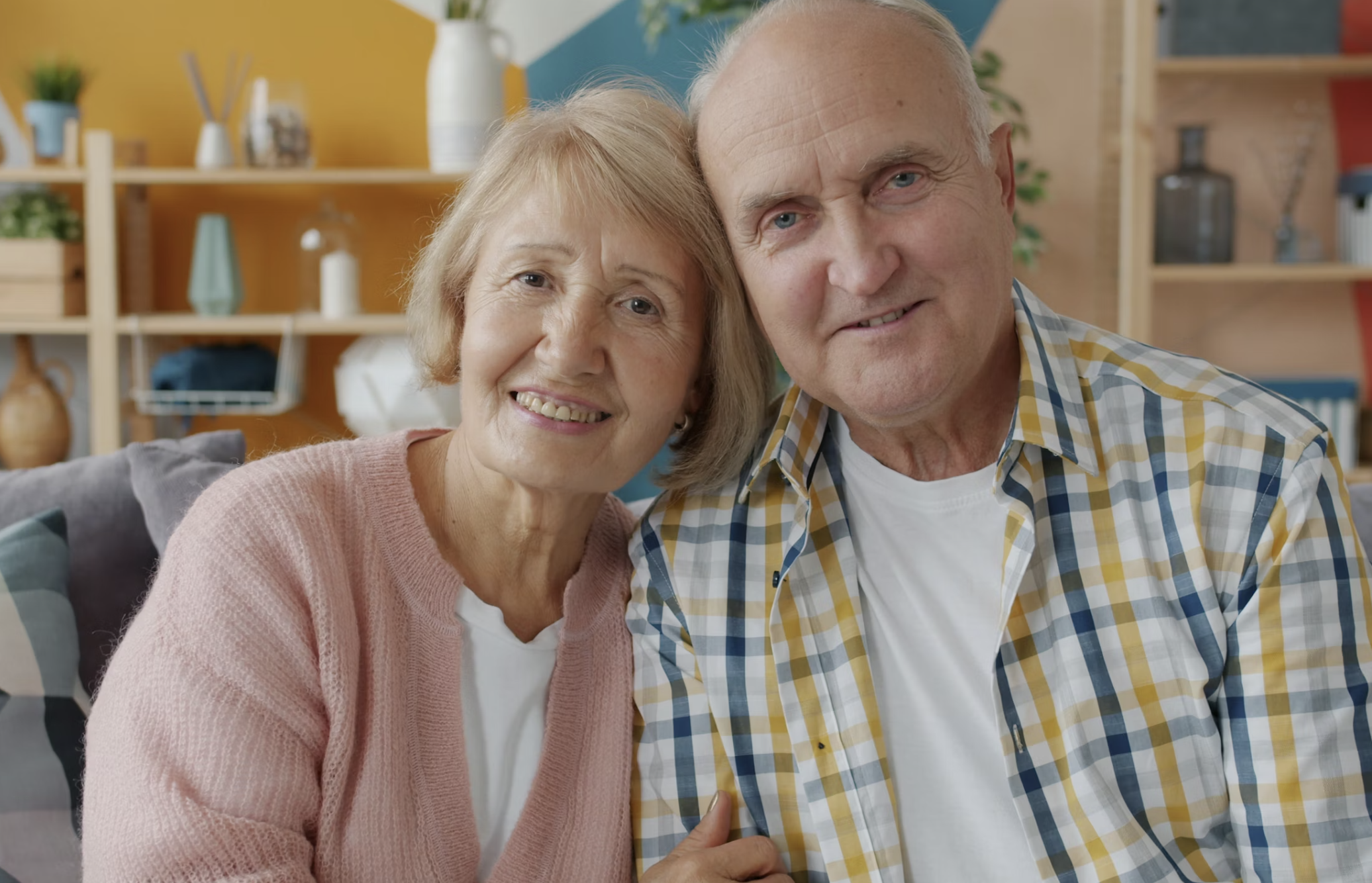 Elderly couple at home in warm living room