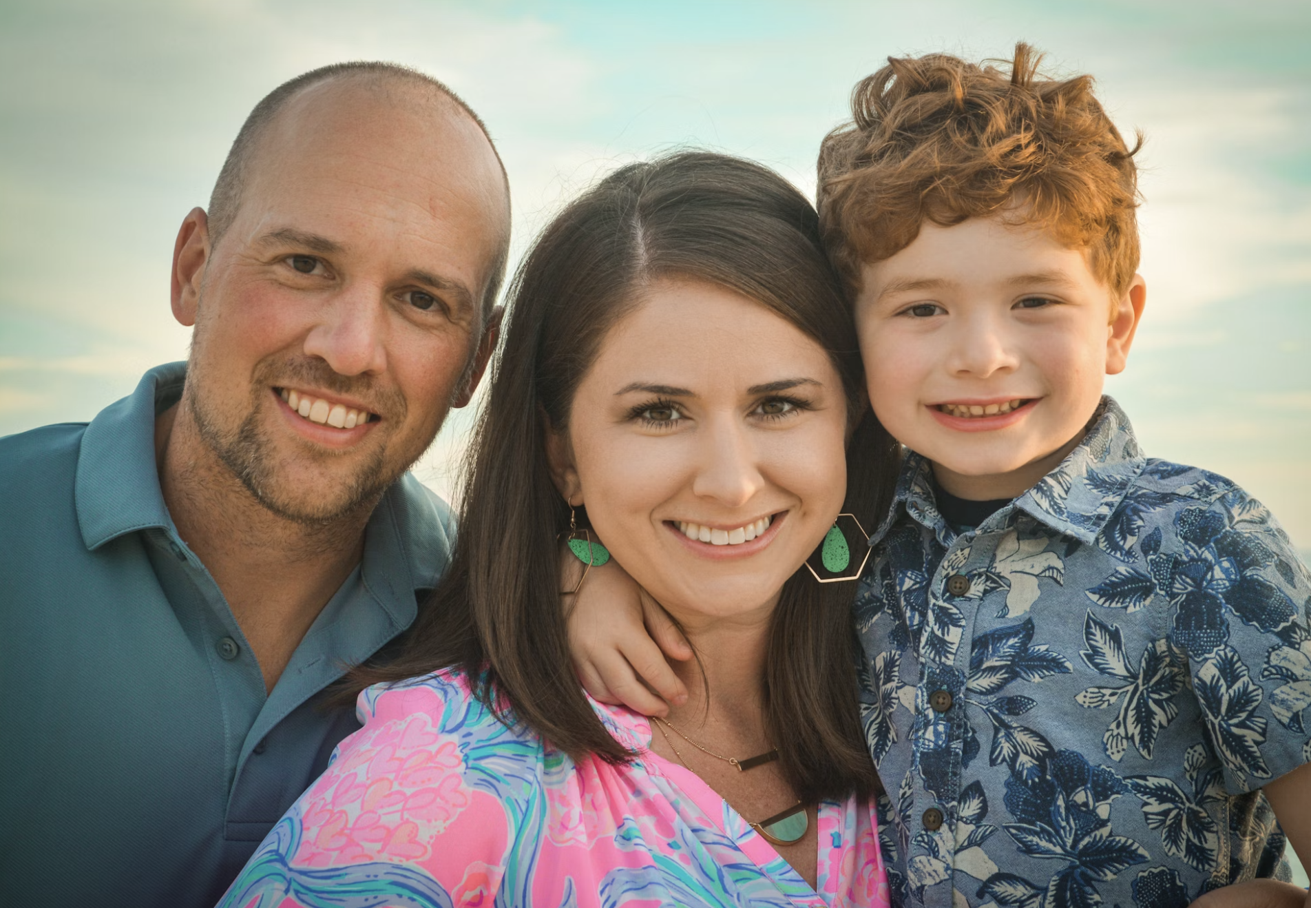 Parents with young son smiling together